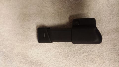 1996 Ford Bronco - Unidentified black plastic automotive part shown against a textured background.