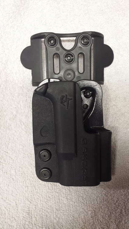 1996 Ford Bronco - A black gun holster with adjustable mounting hardware is shown against a textured surface.