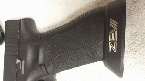 1996 Ford Bronco - Close-up of a pistol grip a ZEVII logo and textured surface.