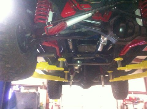 1982 Ford Bronco - The undercarriage of a vehicle is visible, with suspension components and a differential highlighted.