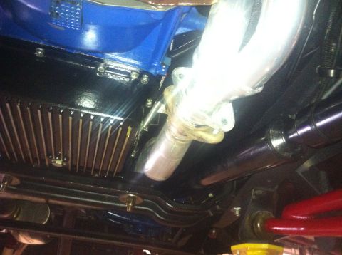 1982 Ford Bronco - Close-up of the engine bay and exhaust system from underneath a vehicle.