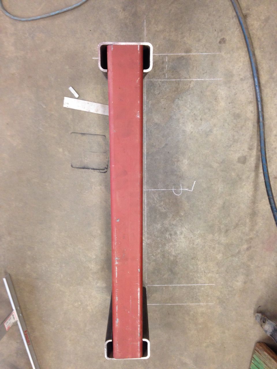 Red metal part with white markings and black end caps
