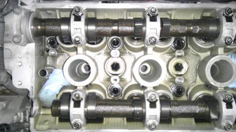 1993 Ford Taurus - Close-up view of an engine's cylinder head with exposed camshafts and valve train components.