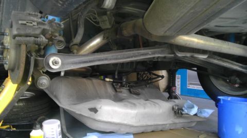 1993 Ford Taurus - The underside of a vehicle is shown with the fuel tank removed for maintenance.