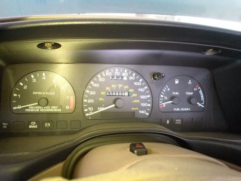 1993 Ford Taurus - Close-up of a car's instrument cluster, showing the speedometer, tachometer, and fuel/temperature gauges.