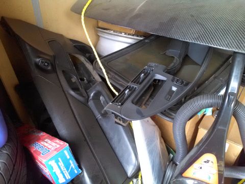 1993 Ford Taurus - Various car interior parts are stored together with household items.
