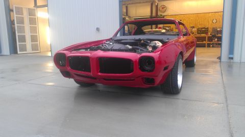 1972 Pontiac Trans Am - Front view of a red 1970s muscle car, possibly a Pontiac Firebird, with its hood open.