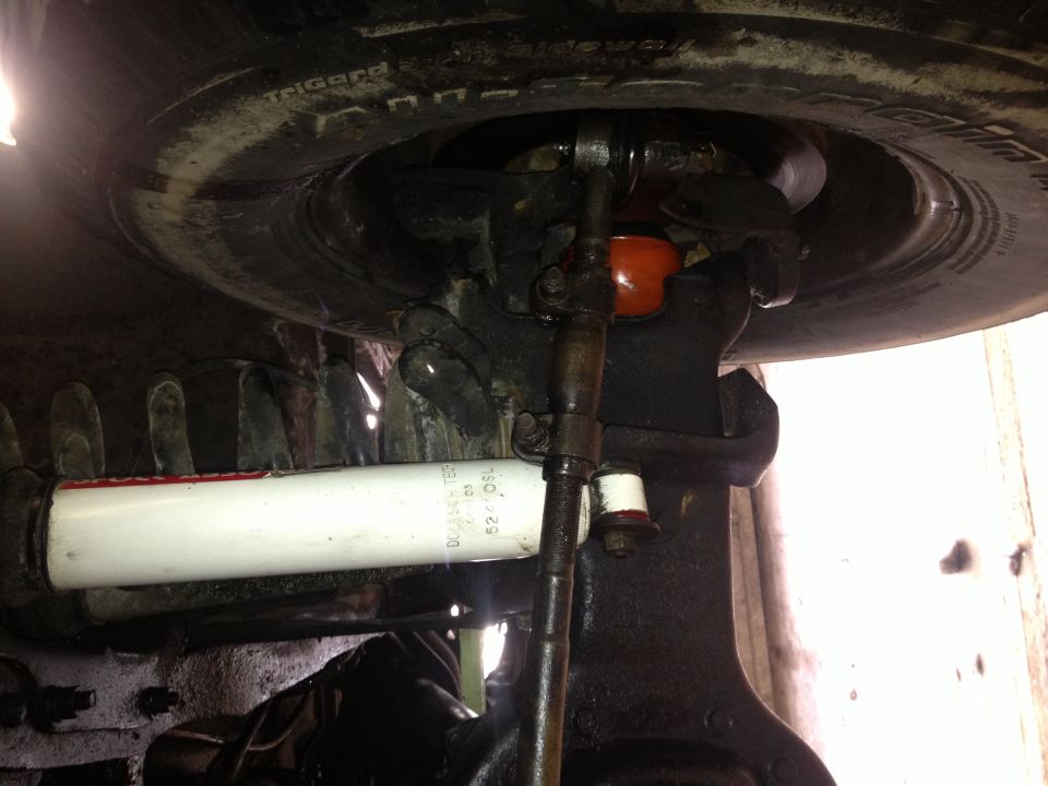 close-up of vehicle's steering linkage and shock absorber