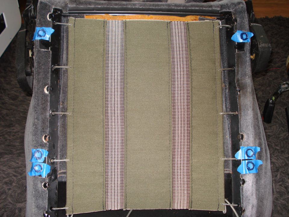 Car seat interior with green fabric and vertical striped inserts
