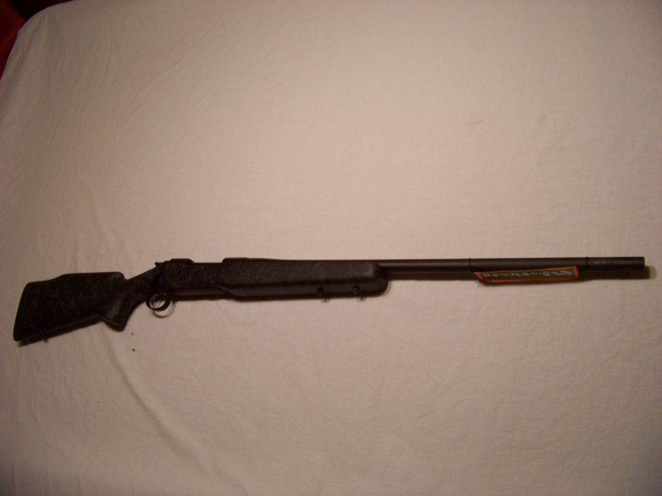 Black rifle with orange label on barrel