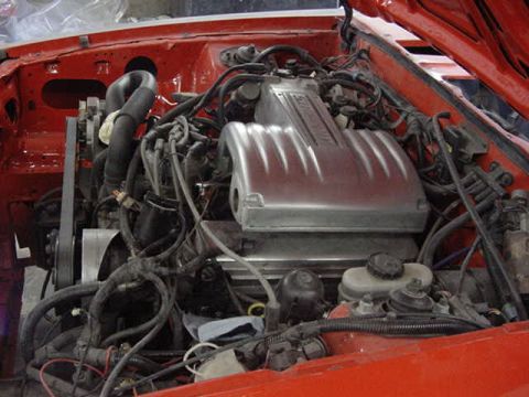 1990 Ford F-150 - Close-up view of a vehicle's engine bay, showing the V8 engine and associated components.