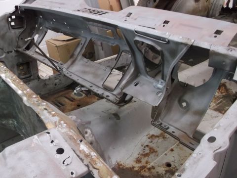 1967 Ford Mustang - The interior dashboard frame of a 1967 Ford Mustang is shown during a restoration project, revealing its bare metal construction.