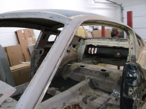 1967 Ford Mustang - This car body is undergoing restoration, with most interior components removed and visible rust.