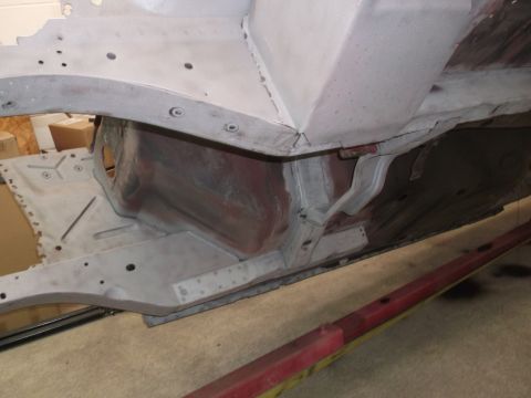 1967 Ford Mustang - The underside of a vehicle is shown, with visible structural components and some red primer. The registry information may be inaccurate.