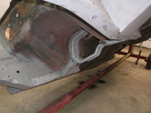 1967 Ford Mustang - Undercarriage view of a 1967 Ford Mustang, likely during restoration or repair work.