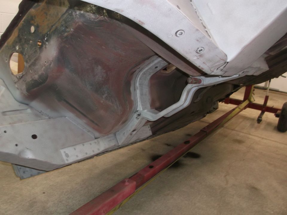 Undercarriage of a 1967 Ford Mustang showing the frame and suspension components