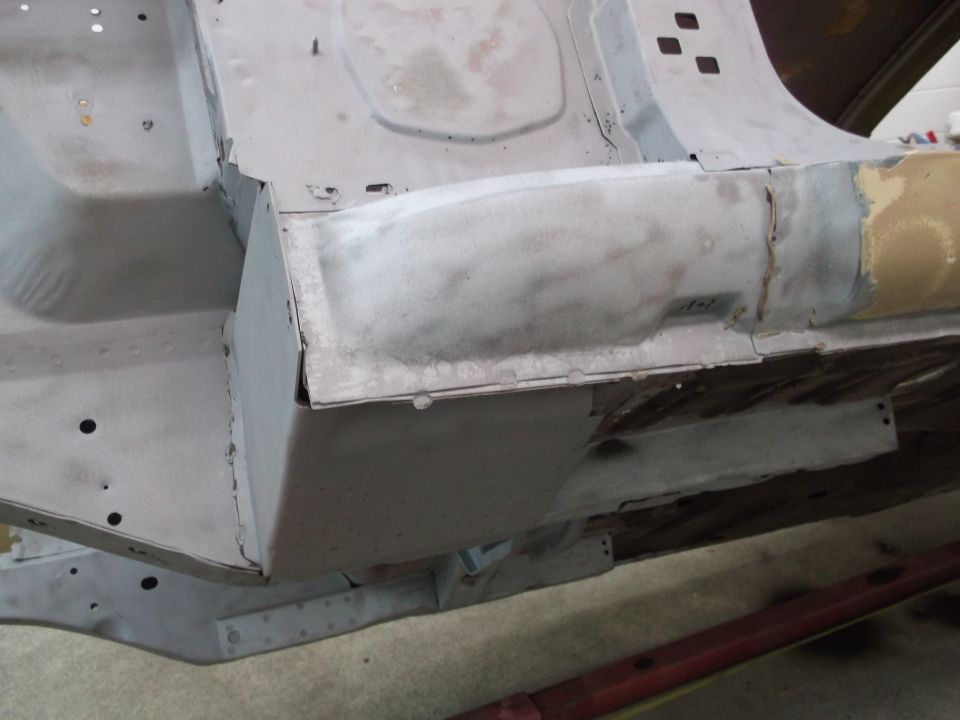 Close-up of car's undercarriage showing metal repair work on the frame