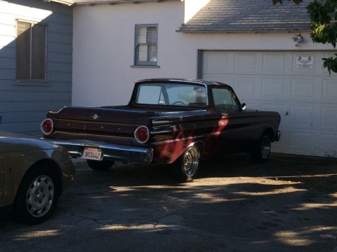 1968 Ford Mustang - This 1960 Ford Falcon Ranchero is parked in front of a garage, with another car partially visible in the foreground.