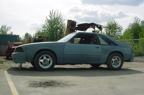 1990 Ford F-150 - This unfinished gray coupe is seen from the side, with its bodywork appearing to be in a primer state.