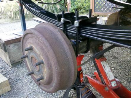 1982 Ford Bronco - Close-up of a vehicle's rear suspension and brake drum assembly.