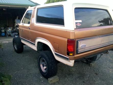 1982 Ford Bronco - Rear view of a lifted Ford Bronco with a two-tone paint scheme.