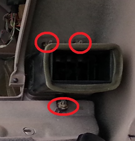 1994 Ford Bronco - Close-up of a car's interior air vent, with screws circled in red. Text from a watermark is visible at the bottom.