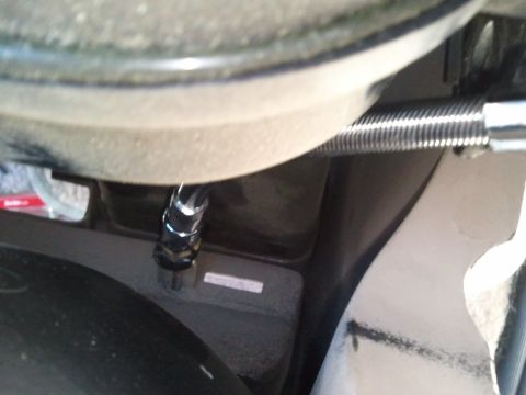 1994 Ford Bronco - Close-up view of a dashboard interior part with a visible metal rod and corrugated tubing.