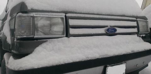 1988 Ford Bronco - Front view of a 1987 Ford Bronco covered in snow.