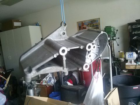 1996 Ford Bronco - A metal component is suspended by a blue strap, with garage equipment visible in the background.