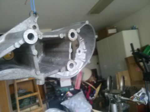 1996 Ford Bronco - Aluminum part suspended by a rope, with garage clutter in the background.