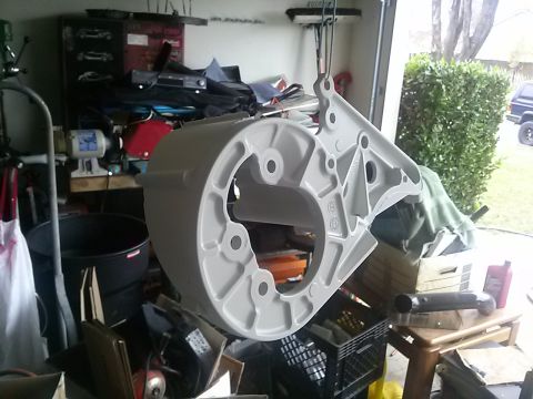 1996 Ford Bronco - A large, painted metal component is suspended in a cluttered garage environment.