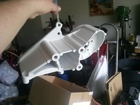1996 Ford Bronco - A white painted metal component is held up by wires, with a workshop environment in the background.