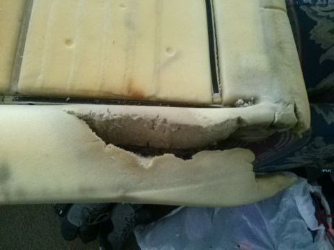 1996 Ford Bronco - Close-up of torn car seat foam, revealing the internal structure and wear.