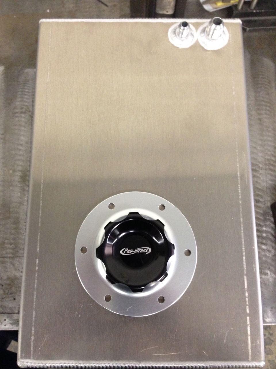 Aluminum fuel tank with a black "Pro-werks" cap and two fittings on top