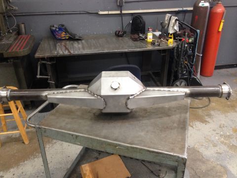 1992 Ford Crown Victoria - A custom fabricated rear axle assembly sits on a workbench in a workshop environment.