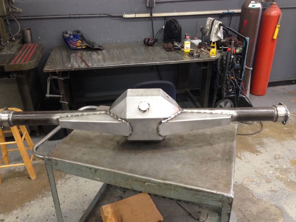 Polished metal rear axle assembly with a hexagonal center section and circular cap