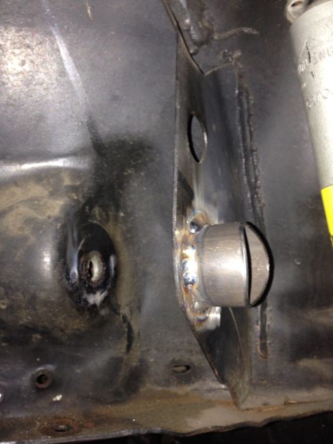1992 Ford Crown Victoria - Detail of a welded bracket on a vehicle frame, with visible weld beads and a hole.