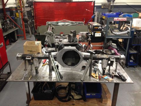 1992 Ford Crown Victoria - A rear axle assembly is shown on a workbench in a fabrication shop.