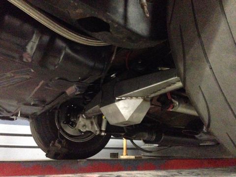 1992 Ford Crown Victoria - A close-up view of a vehicle's undercarriage, focusing on the suspension components and a prominent tire.