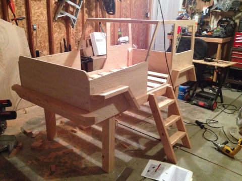 2005 Jeep Wrangler - A wooden bed frame designed to resemble a Jeep is shown in a garage setting, complete with a ladder for access.