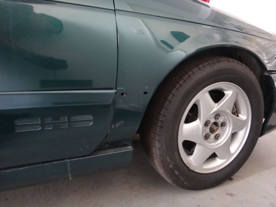 Green 1993 Ford Taurus SHO fender with 'SHO' badging and alloy wheel
