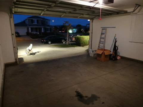 1993 Ford Taurus - View from inside a garage at dusk, showing a parked car and a suburban house.