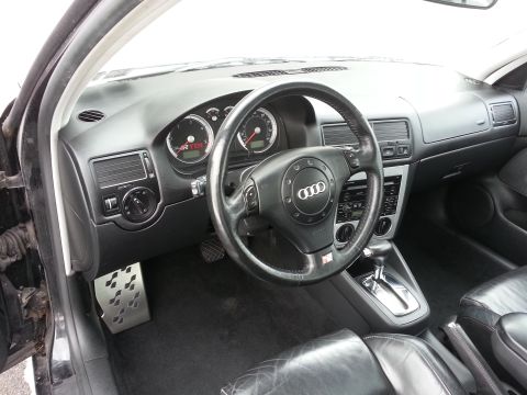 2002 Volkswagen Jetta - The dashboard and steering wheel of a car are visible, an Audi logo and a TDI badge.