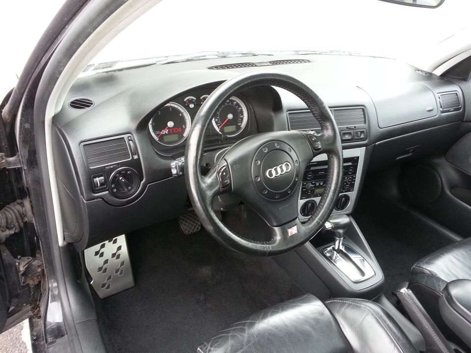 Interior shot of a car with an Audi steering wheel and TDI badge on the dash
