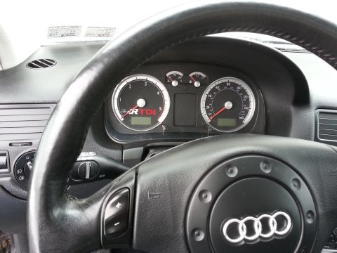 2002 Volkswagen Jetta - The dashboard of a car is visible, gauges and a steering wheel that displays an Audi logo, despite the registry claiming it is a 2002 Volks…