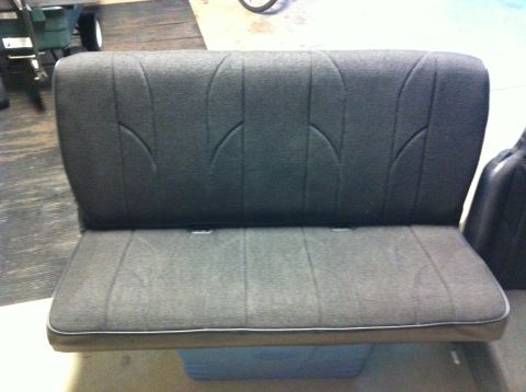 1982 Ford Bronco - This is a gray car seat with a distinct stitching pattern on the backrest.