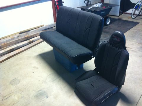 1982 Ford Bronco - A bench seat and a bucket seat are shown in a garage setting.