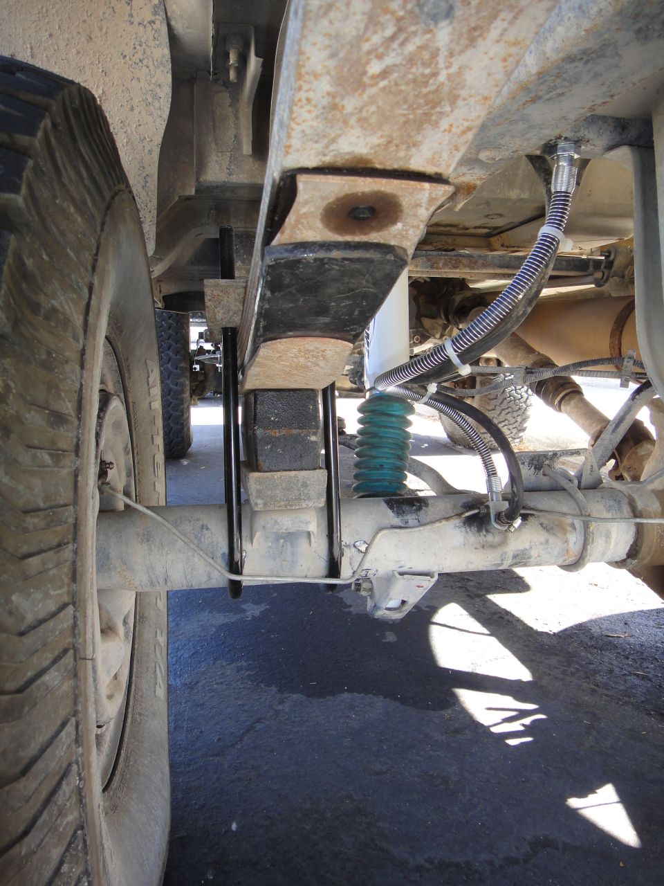 Close-up of rear leaf springs and airbags on a vehicle's suspension system