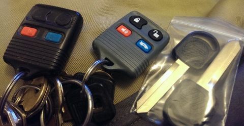 2000 Mercury Grand Marquis - Car keys and fobs, including one with a Mercury emblem, are laid out on a textured surface.