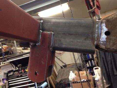1993 Ford Bronco - A close-up view of a welded metal frame part, showing the connection between red and silver components.